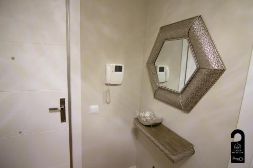 a bathroom with a mirror and a sink at Cuencaloft Cervantes in Cuenca