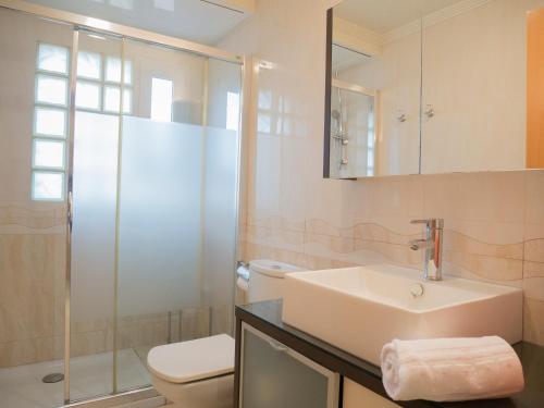 a bathroom with a sink and a toilet and a shower at VILLA CHALET CAP I CORP in Alcossebre