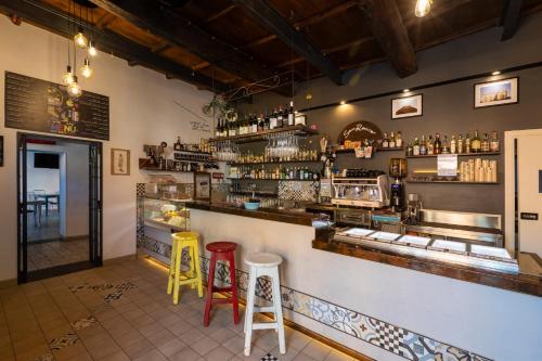 a bar with colorful stools in a restaurant at B&b San Rocco in Celleno