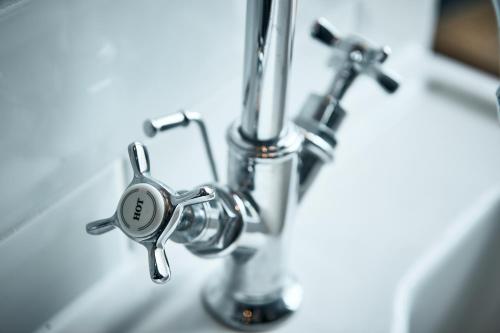 a close up of a bathroom sink with a faucet at The Brown's Hotel in Laugharne