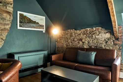 a living room with a couch and a table at The Brown's Hotel in Laugharne
