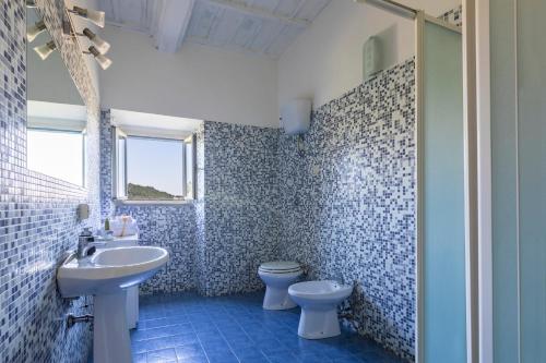 a bathroom with a sink and a toilet at B&b San Rocco in Celleno