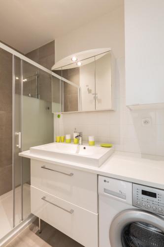 une cuisine blanche avec un évier et une machine à laver dans l'établissement DIFY Stoppa - Lyon Parilly, à Vénissieux