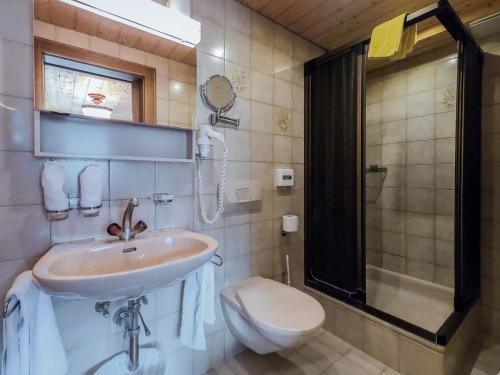 a bathroom with a sink and a toilet and a shower at Garni Soldanella in Samnaun