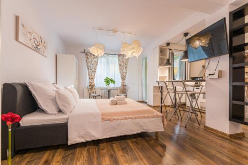 a living room with a couch and a table at Alessia Homes Coressi in Braşov