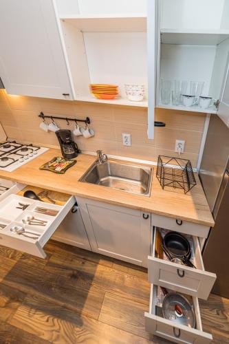 a kitchen with a sink and a counter top at Alessia Homes Coressi in Braşov