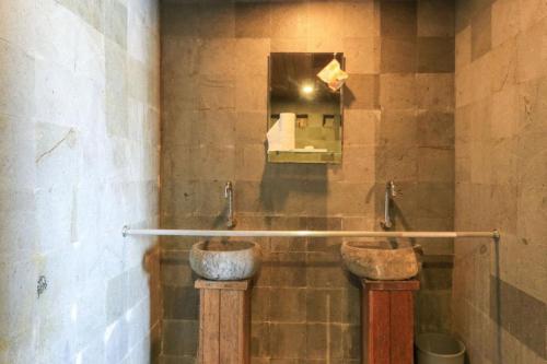 a bathroom with two sinks and a mirror at Waterside inn Nusa Penida in Nusa Penida