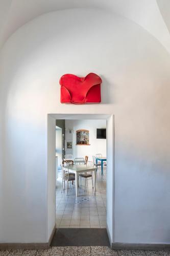 a room with a table and a red pillow on the wall at B&b San Rocco in Celleno