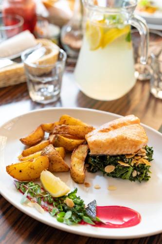 a plate of food with a sandwich and french fries at Hotel Willa Złota in Karwia