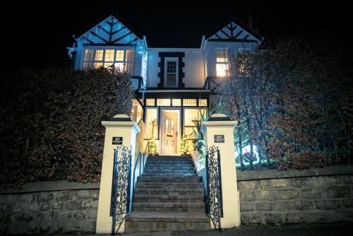 a house with a staircase leading to the front door at night at NORTHRISE RETREAT in Hastings