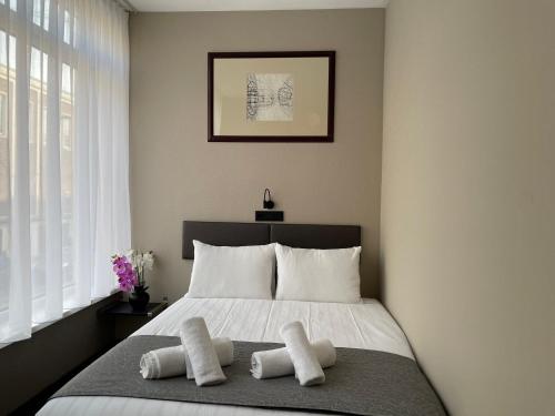 a bedroom with a bed with two pillows on it at H3 Hotel Rotterdam City Center in Rotterdam