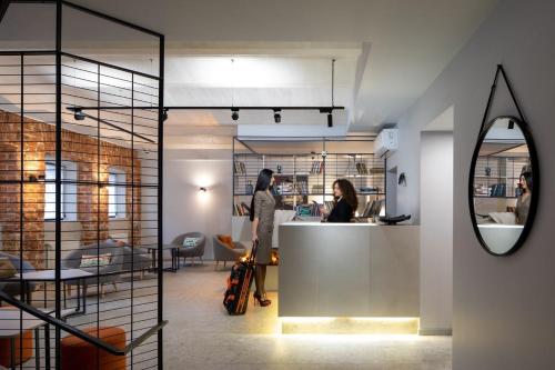 two people standing at a counter in a room at Four Rooms City in Kharkiv