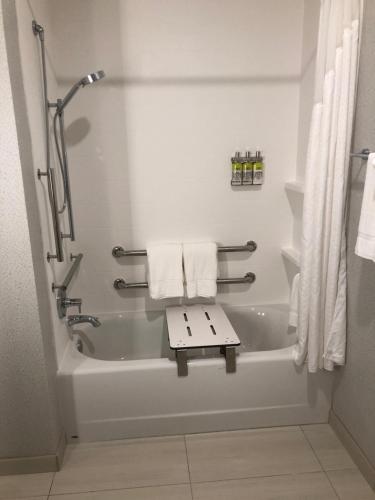 a bathroom with a bath tub with towels on it at Holiday Inn Express & Suites - Madison West - Middleton by IHG in Middleton