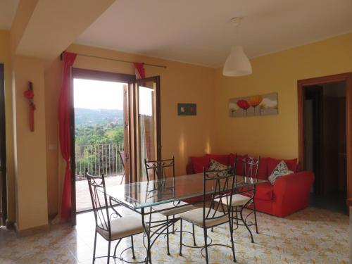 a dining room with a glass table and chairs at Case Vacanze Residence Trinacria in Acireale