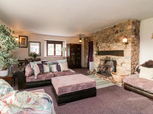 a large living room with a stone fireplace at Swallows Nest at Magnolia Lake in Exeter