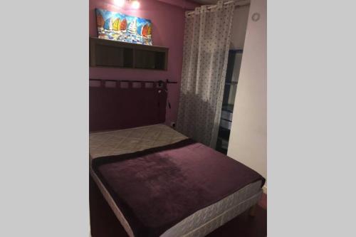 un petit lit dans une chambre avec une fenêtre dans l'établissement Studio meublé 28m2 vue côté Balaruc centre et massif de la Gardiole, à Balaruc-les-Bains