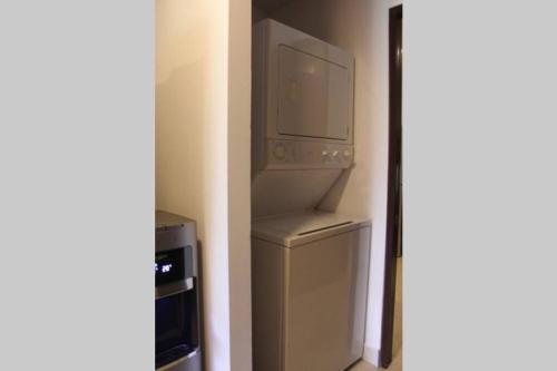 a kitchen with a refrigerator and a microwave at Luxury Apartment in Nuevo Vallarta Villamagna Condo in Nuevo Vallarta 