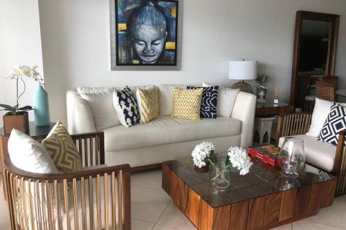 a living room with a couch and a table at Luxury Apartment in Nuevo Vallarta Villamagna Condo in Nuevo Vallarta 