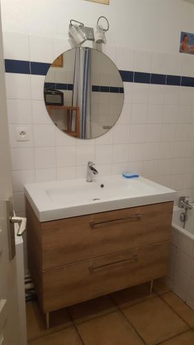 a bathroom with a sink and a mirror at Saint Martin in Saint-Martin-de-Ré
