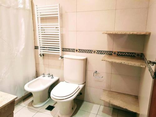 a bathroom with a toilet and a sink at Administracion Callao in Buenos Aires