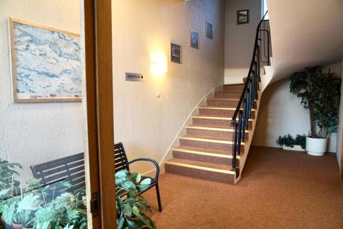 a staircase leading up to a room with a balcony at Ro Hotel in Geilo