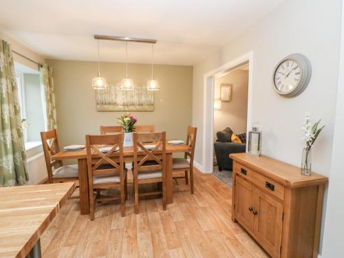 a dining room and living room with a table and chairs at October Cottage in Barnard Castle