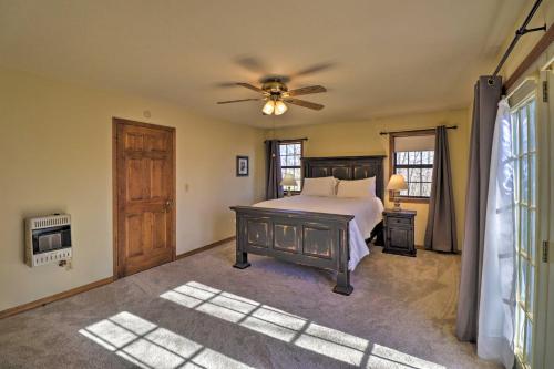 a bedroom with a bed and a ceiling fan at Secluded Marble Falls Family Home with Mtn Views! in Marble Falls