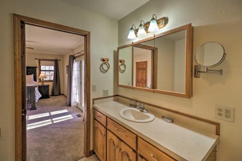 a bathroom with a sink and a mirror at Secluded Marble Falls Family Home with Mtn Views! in Marble Falls
