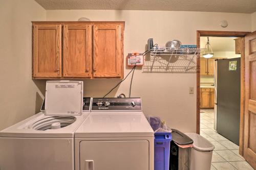 a kitchen with a washing machine and a refrigerator at Secluded Marble Falls Family Home with Mtn Views! in Marble Falls