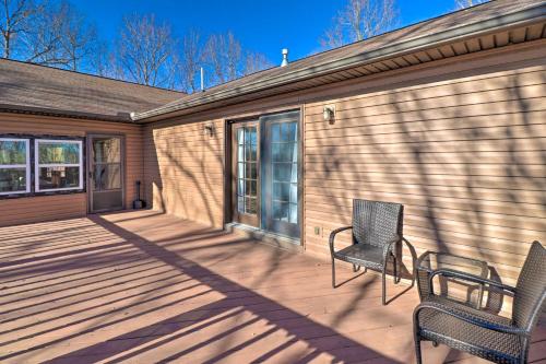 a porch with two chairs and a house at Secluded Marble Falls Family Home with Mtn Views! in Marble Falls