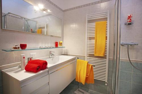 a bathroom with a sink and a shower with a red towel at TREMEZZO RESIDENCE 2 in Tremezzo