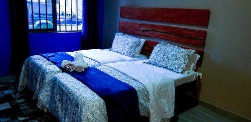 a bedroom with a bed with a stuffed animal on it at Sweet Retreat in Lusaka