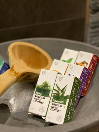 a table with a wooden spoon and packets of food at Family & Business Sauna Apartments No1 Leśny nad Zalewem Cedzyna Unikat - 3 Bedroom with Private Sauna, Bath with Hydromassage, Terrace, Garage, Catering Options in Kielce