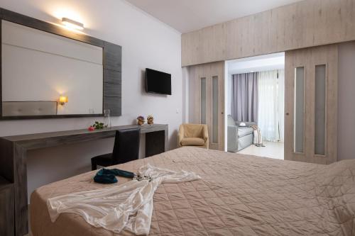 a hotel room with a bed and a mirror at Lagomandra Hotel and Spa in Lagomandra