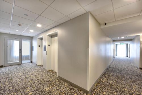 an empty corridor in a office building with a hallway at Staybridge Suites - Waterloo - St. Jacobs Area in Waterloo