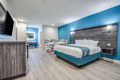 a hotel room with a bed and a flat screen tv at Americas Best Value Inn & Suites Houston at Hwy 6 in Houston