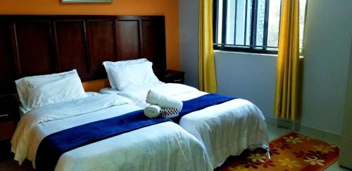 a bedroom with a bed with a teddy bear on it at Sweet Retreat in Lusaka