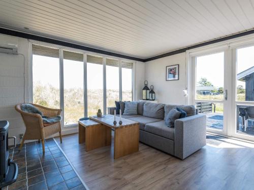 a living room with a couch and a table at 4 person holiday home in Fanø in Fanø
