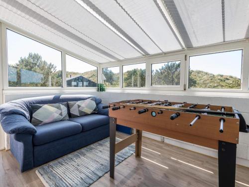 a living room with a couch and a foosball table at 4 person holiday home in Fanø in Fanø