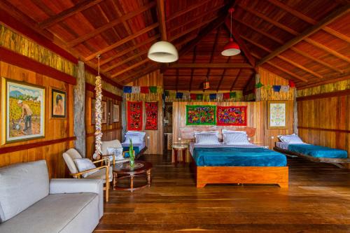 a living room with two beds and a couch at Villa Papagaio in Jijoca de Jericoacoara