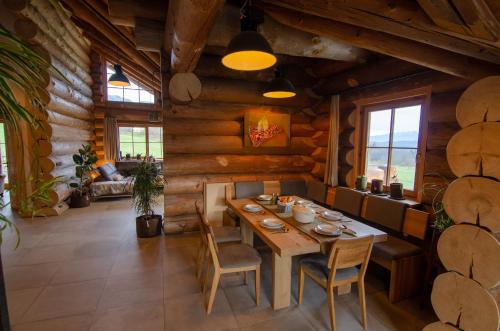a dining room with a wooden table and chairs at Berg & Sonne in Seeboden