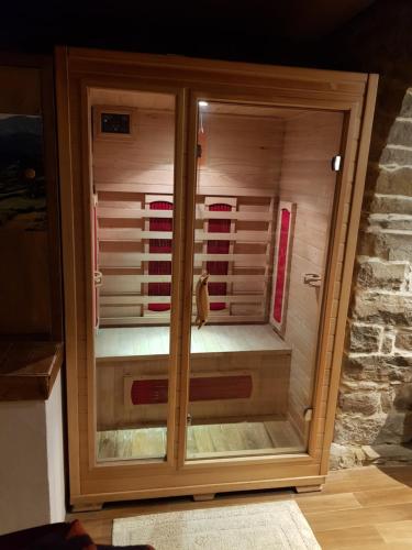 a wooden cabinet with glass doors in a room at Alla Battuta in Sansepolcro