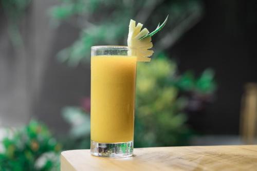 a glass of orange juice sitting on a table at Ranggen Ubud in Ubud