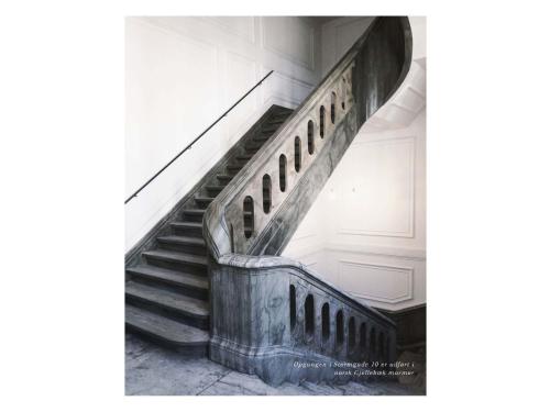 a staircase in an old building with a metal railing at ApartmentInCopenhagen Apartment 1185 in Copenhagen