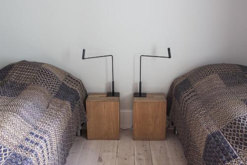 two beds in a room with two night stands at ApartmentInCopenhagen Apartment 1185 in Copenhagen