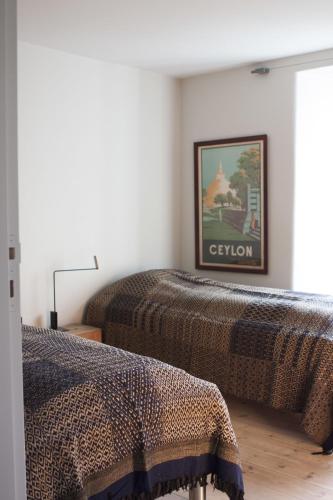 two beds in a room with a picture on the wall at ApartmentInCopenhagen Apartment 1185 in Copenhagen