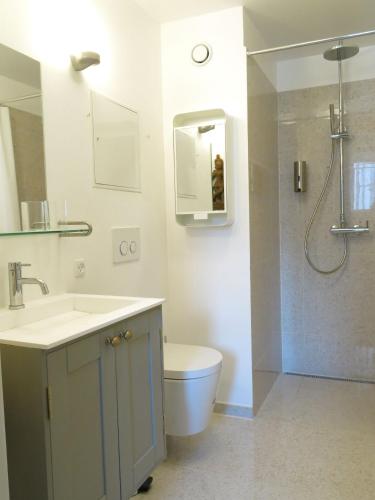 a bathroom with a sink and a toilet and a shower at ApartmentInCopenhagen Apartment 1185 in Copenhagen