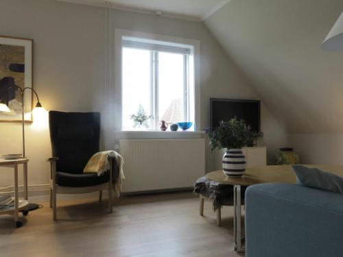 a living room with a couch and a window at ApartmentInCopenhagen Apartment 1240 in Copenhagen