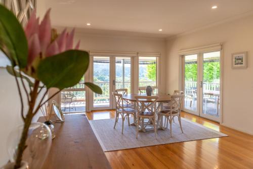 a dining room with a table and chairs at Views On Montpellier in Healesville