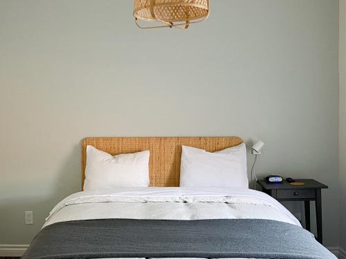 a bedroom with a large bed with white pillows at The Bayview Motel - Fort Frances, ON - Lakeside Motel in Fort Frances